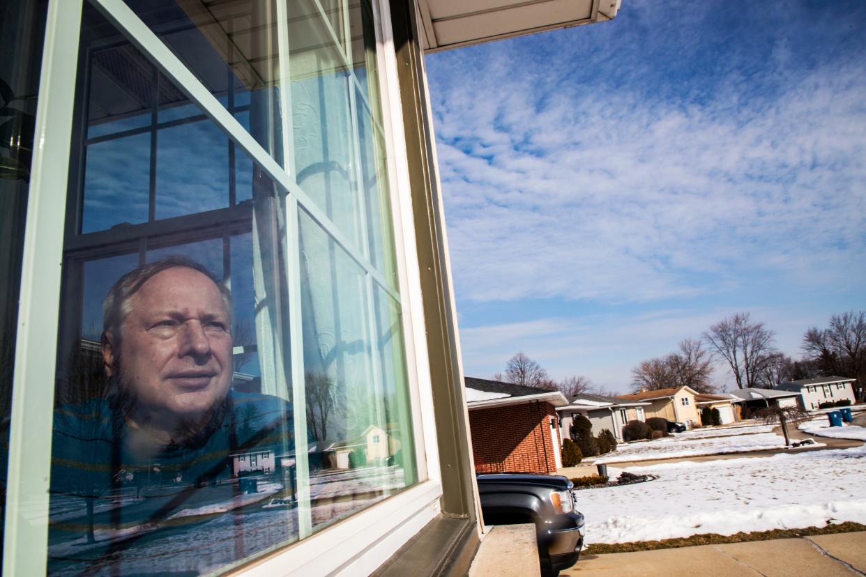 In this Feb. 11, 2020, photo, Ken Zurek, 63, poses for a photo at his home in Highland, Ind. Zurek and his wife arrived in China days before news broke of the coronavirus. They cut their trip short because of the virus and decided to self quarantine themselves in their Highland home for 15 days, just as an extra precaution. (Zbigniew Bzdak/Chicago Tribune via AP)