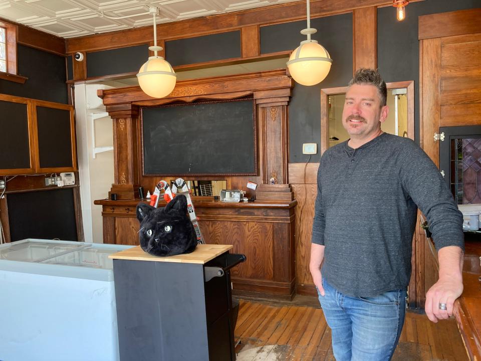 Alex Carter, owner of Black Cat Ice Cream, stands inside his Drake neighborhood storefront.