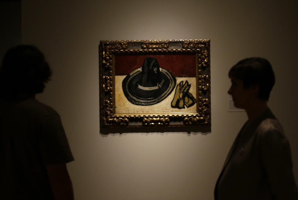 A painting by Marsden Hartley titled "Sombrero with Gloves," is viewed during a press preview of the exhibit "Hotel Texas: An Art Exhibition for the President and Mrs. John F. Kennedy," during a press preview at the Dallas Museum of Art Wednesday, May 22, 2013, in Dallas. (AP Photo/LM Otero)