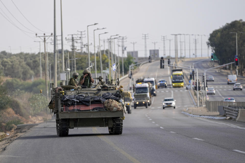 An Israeli armoured personnel carrier (APC) moves on a road towards the Gaza Strip border in southern Israel Monday, Oct. 16, 2023. (AP Photo/Ohad Zwigenberg)