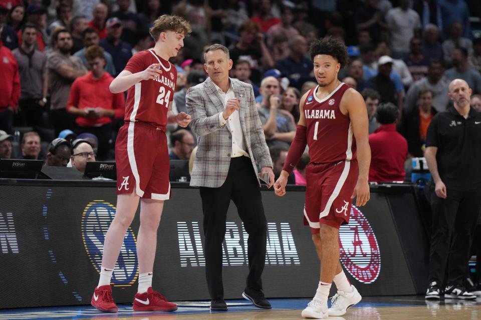 Alabama coach Nate Oats talks with forward Sam Walters (24) and guard Mark Sears (1) during their game against North Carolina in the semifinals of the West Regional of the 2024 NCAA men's tournament at Crypto.com Arena.