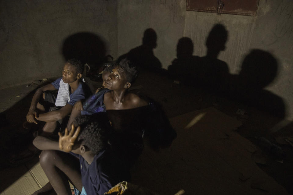 In this July 11, 2019 photo, Ethiopian migrant boys ages 13 to 16, who crossed at night from Ethiopian borders, rest in an abandoned one-floor, brick house in Ali Sabeih, Djibouti. Migrants take shelter here until early morning to continue their journey. (AP Photo/Nariman El-Mofty)
