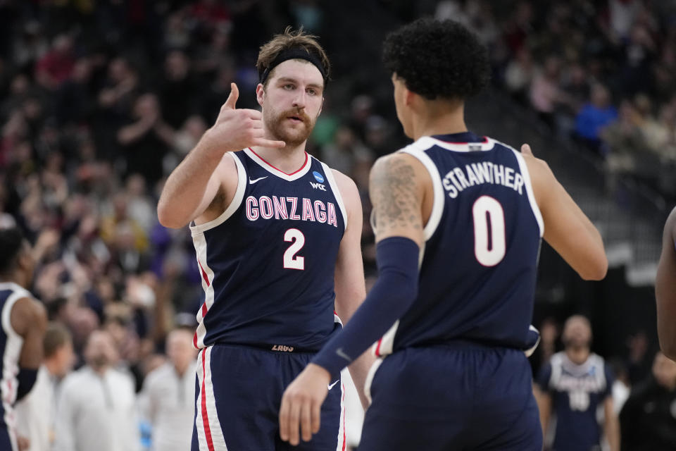 Gonzaga's Drew Timme (2) and Julian Strawther (0) celebrate in the second half of a Sweet 16 college basketball game against UCLA in the West Regional of the NCAA Tournament, Thursday, March 23, 2023, in Las Vegas. (AP Photo/John Locher)