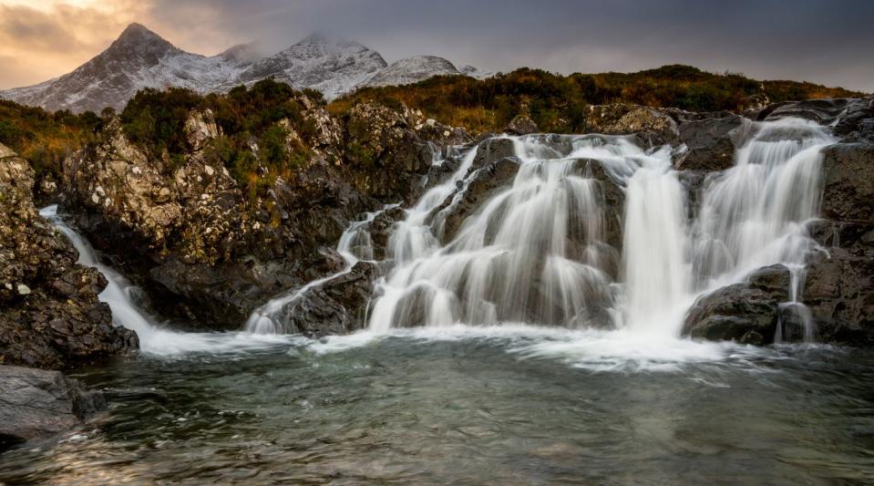 <p>Clouds graze the top of the Cuillin mountains as water flows into a nearby outlet in the Isle of Skye, Scotland // December 12, 2015</p>