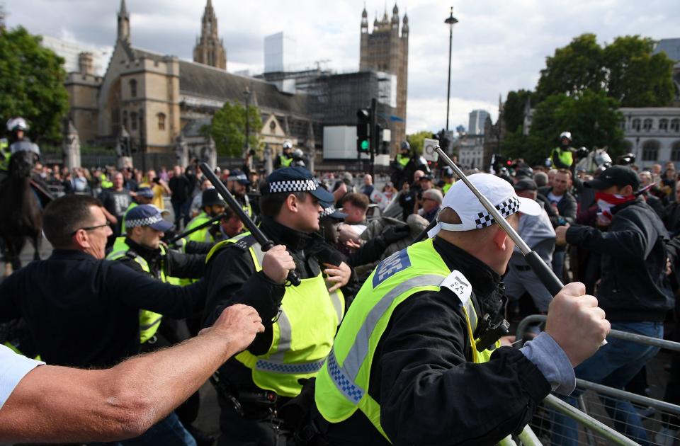 Demonstrators remonstrate with police officers on Parliament Square.