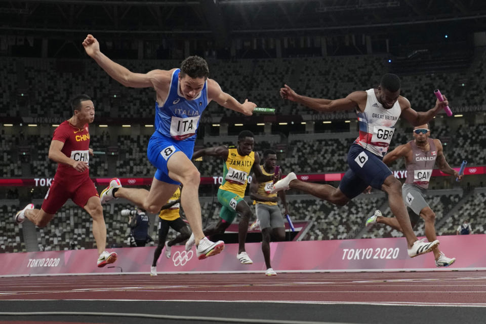 Filippo Tortu, of Italy, crosses the finish line ahead of Nethaneel Mitchell-Blake, of Britain, to lead his to team a gold medal in the men's 4x100-meter relay at the 2020 Summer Olympics, Friday, Aug. 6, 2021, in Tokyo. (AP Photo/David J. Phillip)