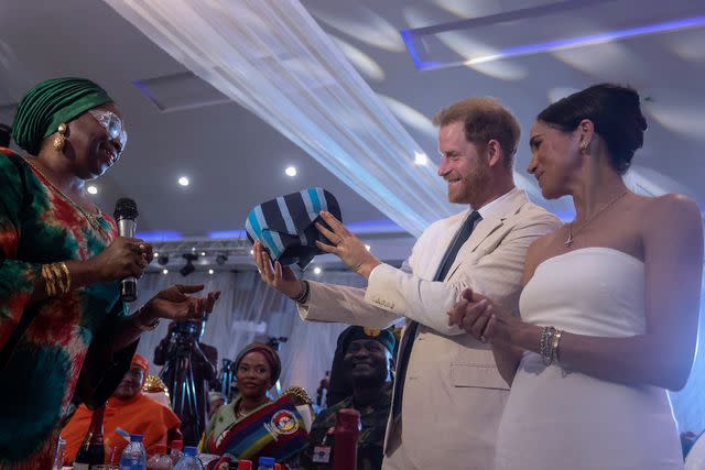<p>KOLA SULAIMON/AFP via Getty</p> Prince Harry and Meghan, Duchess of Sussex attend a reception in Abuja, Nigeria, on May 11, 2024