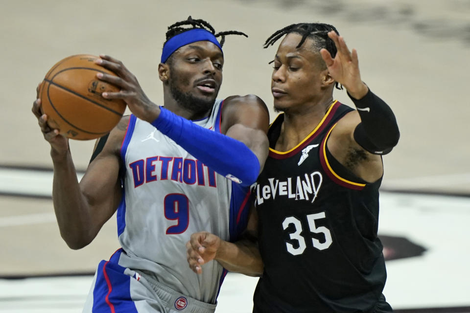 Detroit Pistons' Jerami Grant (9) drives against Cleveland Cavaliers' Isaac Okoro (35) in the second half of an NBA basketball game, Wednesday, Jan. 27, 2021, in Cleveland. (AP Photo/Tony Dejak)