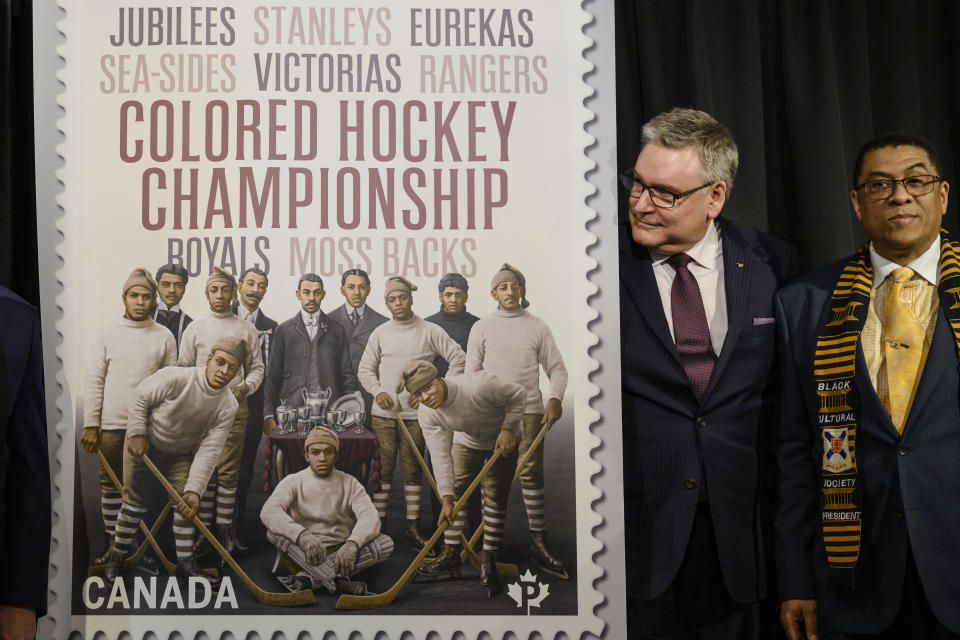 Doug Ettinger, left, President and CEO of Canada Post, and Craig Smith, President of The Black Cultural Society, unveil Canada Post's new stamp honouring the Colored Hockey Championship and the all-Black hockey teams in the Maritimes between 1895 and the early 1930s during an event at the Black Cultural Center in Halifax, Nova Scotia, Thursday, Jan. 23, 2020. (Darren Calabrese/The Canadian Press via AP)