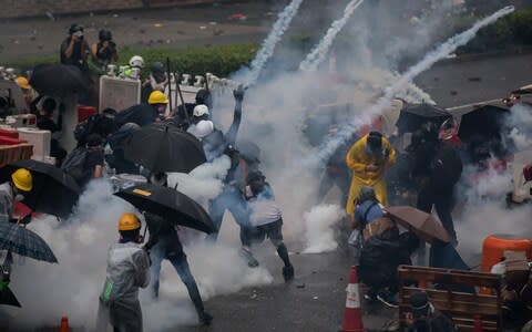 Tear gas lands among protesters in the Tsuen Wan district of Hong Kong on August 25 - Credit: &nbsp;Paul Yeung/Bloomberg