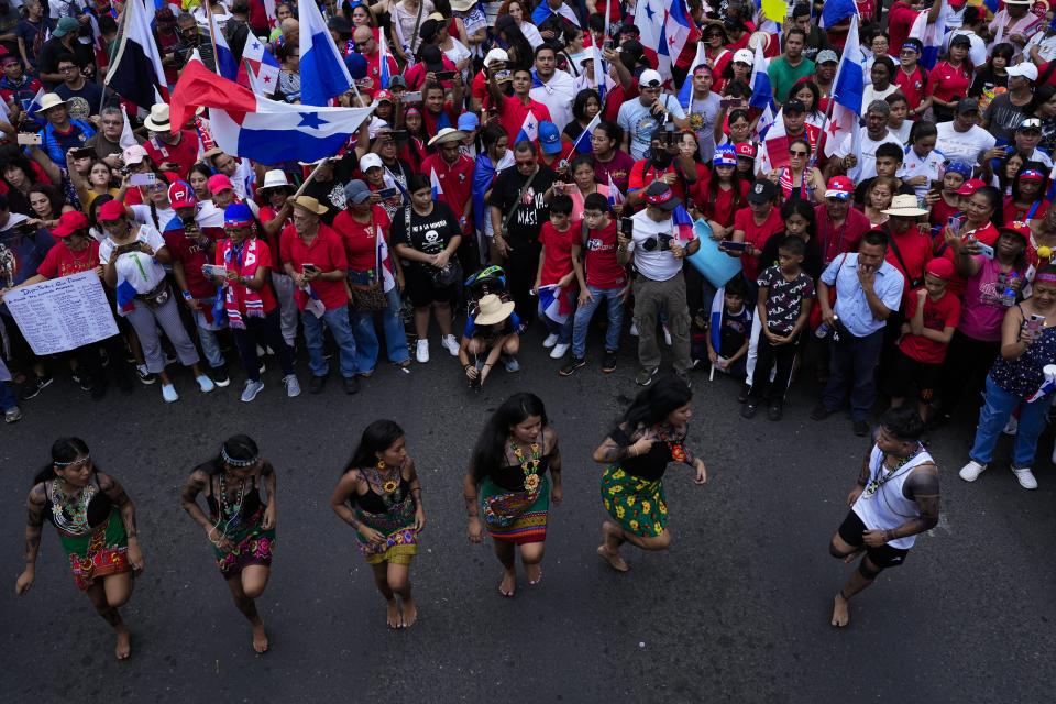 Embera Indigenous women dance as Panamanians celebrate after the Supreme Court declared a 20-year contract with a Canadian copper mine unconstitutional, in Panama City, Tuesday, Nov. 28, 2023. Panama's Supreme Court ruled unanimously that the concession that has been the focus of widespread environmental protests was unconstitutional, after which the president of the Central American country said the process to close the mine would begin. (AP Photo/Arnulfo Franco)