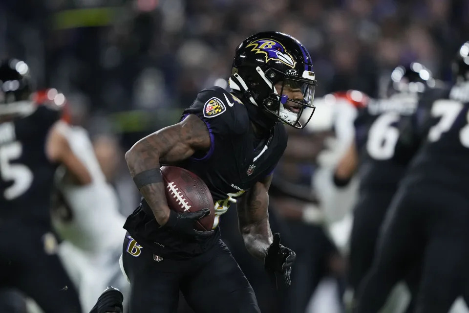 Baltimore Ravens wide receiver Zay Flowers (4) carries the ball in the first half of an NFL football game against the Cincinnati Bengals in Baltimore, Thursday, Nov. 16, 2023. (AP Photo/Matt Rourke)