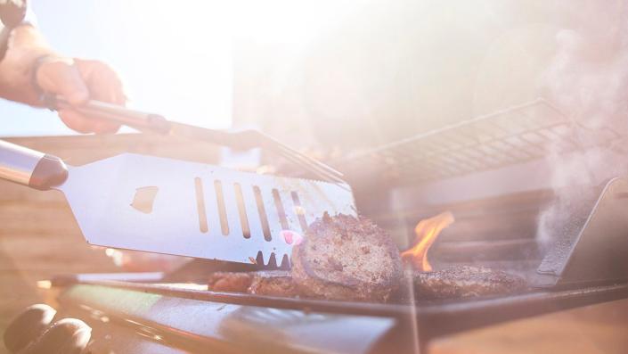 stock image of flipping hamburgers