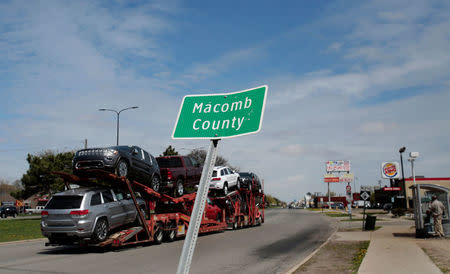 A car hauler drives past a Macomb County sign in the county which flipped from voting for Barack Obama in 2012 to backing Donald Trump in Macomb County, Michigan, U.S., April 24, 2017. REUTERS/Rebecca Cook