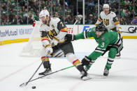 Vegas Golden Knights defenseman Alex Pietrangelo (7) and Dallas Stars defenseman Chris Tanev (3) compete for possession during the first period in Game 2 of an NHL hockey Stanley Cup first-round playoff series in Dallas, Wednesday, April 24, 2024. (AP Photo/Tony Gutierrez)