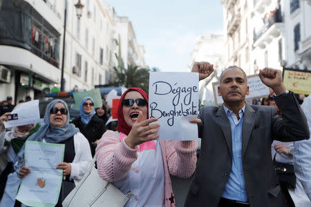 Teachers carry signs and chant slogans during a protest demanding immediate political change in Algiers, Algeria March 13, 2019. The sign reads, "Go away Benghabrit". REUTERS/Zohra Bensemra