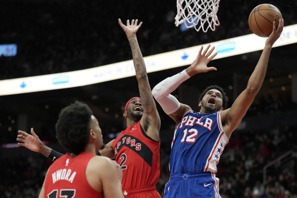 Philadelphia 76ers forward Tobias Harris (12) shoots as Toronto Raptors forward Jalen McDaniels (2) defends during the second half of an NBA basketball game Sunday, March 31, 2024, in Toronto. (Frank Gunn/The Canadian Press via AP)