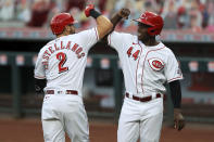 Cincinnati Reds' Nick Castellanos, left. celebrates hitting a two-run home run with teammate Aristides Aquino, right, in the first inning during a baseball game against the Milwaukee Brewers in Cincinnati, Tuesday, Sept. 22, 2020. (AP Photo/Aaron Doster)
