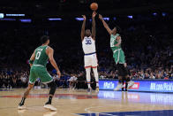 New York Knicks' Julius Randle (30) shoots over Boston Celtics' Aaron Nesmith (26) as Jayson Tatum (0) watches during the first half of an NBA basketball game Wednesday, Oct. 20, 2021 in New York. (AP Photo/Frank Franklin II)