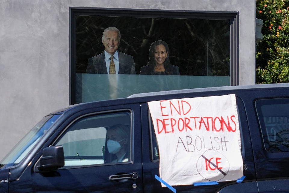 Cutouts of U.S. President Joe Biden and Vice President Kamala Harris are displayed on a window while a protester's vehicle drives by during a rally to demand the end of deportations in Los Angeles, California on March 6, 2021. (Ringo Chiu/Reuters)  