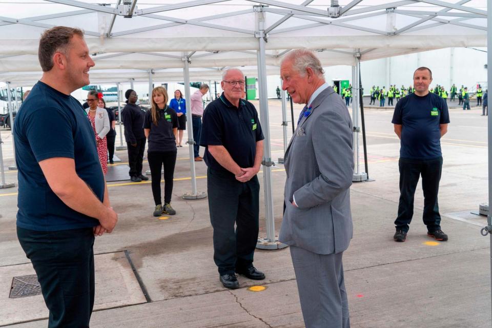 Charles speaks with staff at the distribution centre in Bristol (AFP via Getty Images)