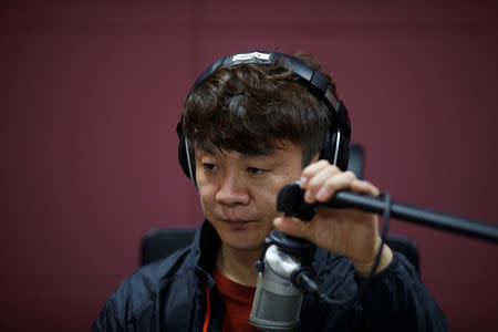 Kim Chung-seong, a North Korean defector and a Christian missionary, adjusts a microphone during a radio broadcast at a radio station in Seoul, South Korea, April 21, 2016. REUTERS/Kim Hong-Ji
