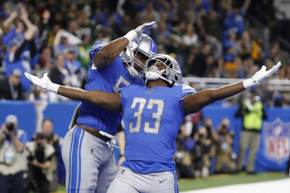 Detroit Lions running back Kerryon Johnson (33) celebrates his 1-yard touchdown run with teammate linebacker Jason Cabinda during the first half of an NFL football game against the Green Bay Packers, Sunday, Dec. 29, 2019, in Detroit. (AP Photo/Rick Osentoski)