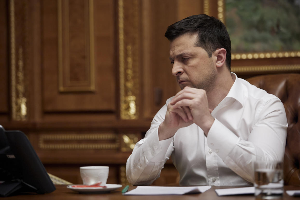 Ukrainian President Volodymyr Zelensky, in his office in Kyiv, talks with President Biden on Friday.