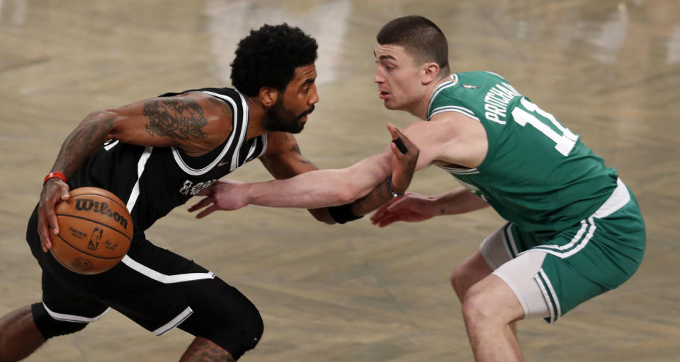 Brooklyn - April 23: The Celtics Payton Pritchard (right) guards the Nets Kyrie Irving (left) in first half action. The Boston Celtics visited the Brooklyn Nets for Game Three of their first round NBA playoff series in Brooklyn, NY on April 23, 2022. (Photo by Jim Davis/The Boston Globe via Getty Images)