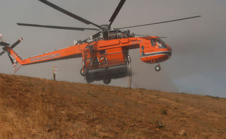 Firefighting helicopters work to contain a wildfire near Oakville, California, U.S., October 16, 2017. REUTERS/Jim Urquhart