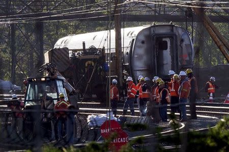 Track workers and officials work at the site of a derailed Amtrak train in Philadelphia, Pennsylvania May 14, 2015. REUTERS/Mike Segar