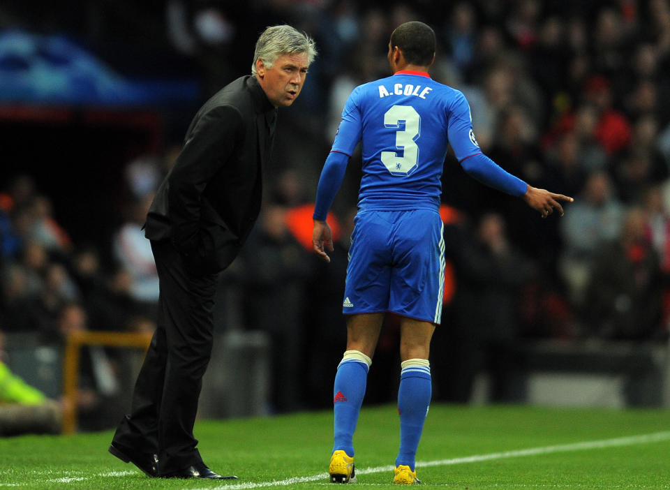 Chelsea's Italian manager Carlo Ancelotti (L) speaks to Chelsea's English defender Ashley Cole during their UEFA Champions League quarter final second leg football match against Manchester United at Old Trafford in Manchester, north west England, on April 12, 2011. AFP PHOTO/ANDREW YATES (Photo credit should read ANDREW YATES/AFP via Getty Images)