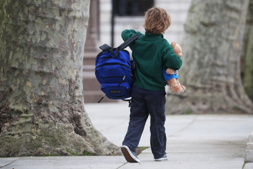 A school child walks in Westminster as the spread of the coronavirus disease (COVID-19) continues, in London, Britain, March 18, 2020. REUTERS/Hannah McKay