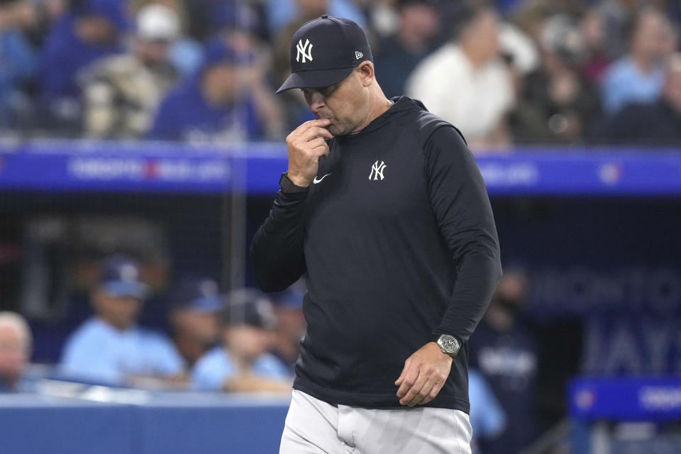 New York Yankees manager Aaron Boone walks off the field after umpire James Hoye ejected Yankees pitcher Domingo German during the fourth inning of the team's baseball game against the Toronto Blue Jays on Tuesday, May 16, 2023, in Toronto. (Chris Young/The Canadian Press via AP)