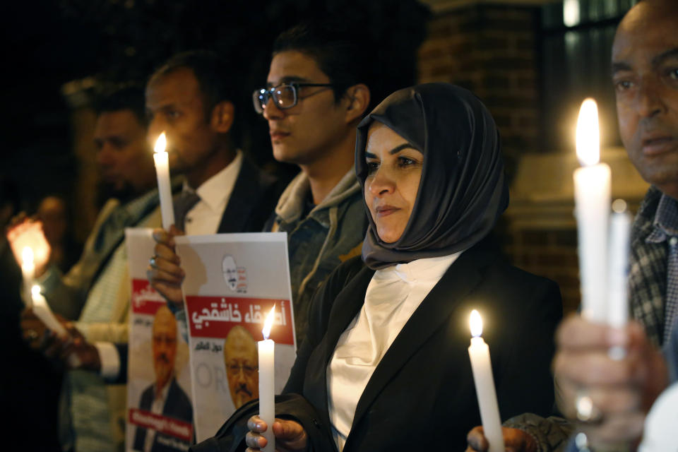 Activists protesting the killing of Saudi journalist Jamal Khashoggi hold a candlelight vigil outside Saudi Arabia's consulate in Istanbul, Thursday, Oct. 25, 2018. A group of Arab and international public, political and media figures are establishing a global association called "Khashoggi's Friends Around the World"; "to achieve justice for the freedom martyr".(AP Photo/Lefteris Pitarakis)