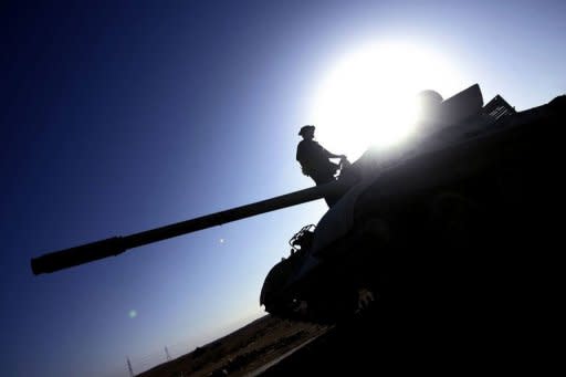 Libyan National Transitional Council (NTC) fighters drive tanks at an outpost on the outskirts of the city of Bani Walid. Libya's new rulers on Wednesday declared victory in the battle for the key southern city of Sabha, one of the last bastions of deposed despot Moamer Kadhafi's diehard supporters