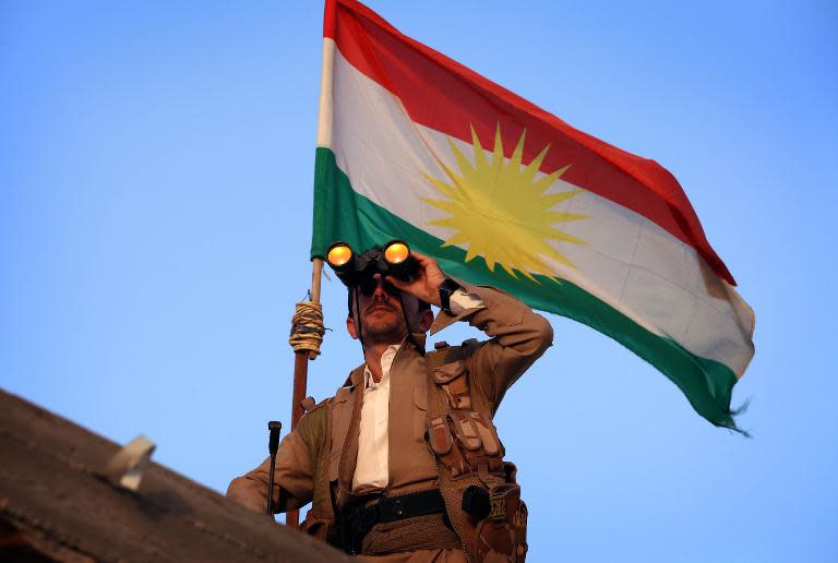 A Kurdish Peshmerga fighter holds a position on the front line in the Gwer district, 40 kilometres south of Arbil, the capital of the Kurdish autonomous region in northern Iraq, on September 18, 2014