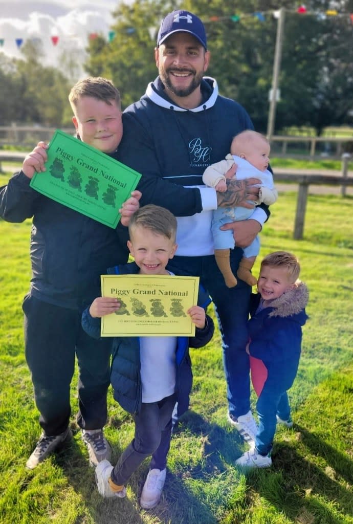 Ricky Smith with his children Louie, Karson and Arlo and stepson Roman. Katrina Binfield / SWNS