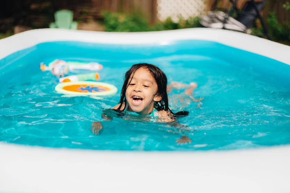 little girl playing in a kiddie pool