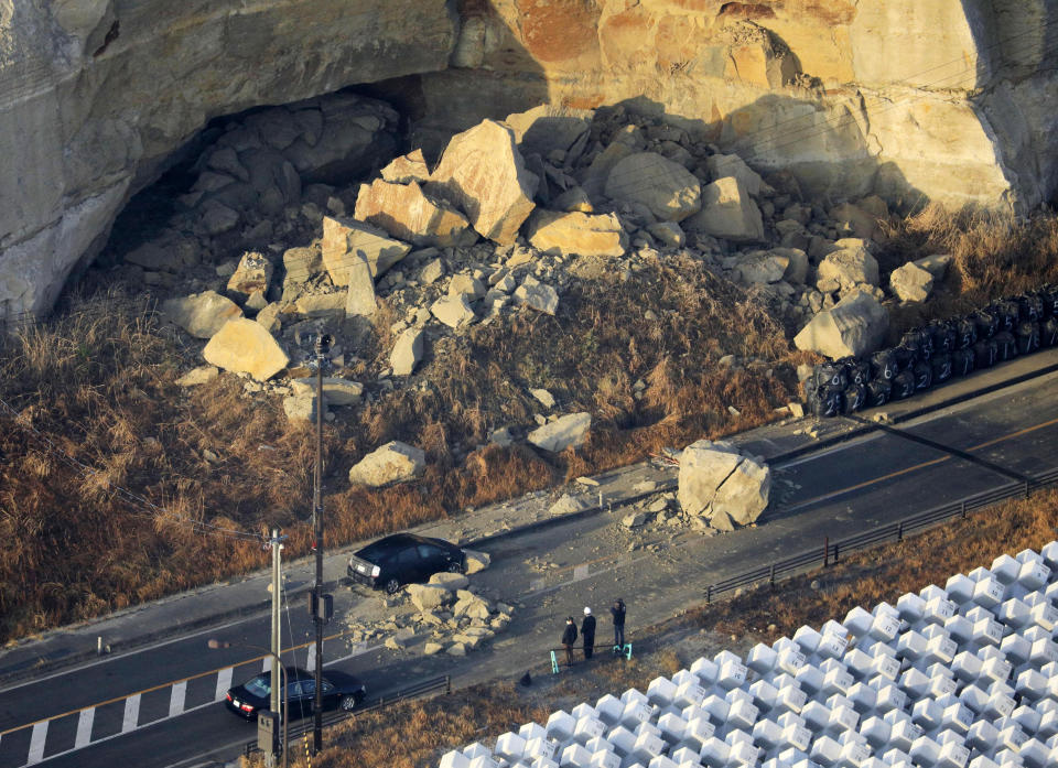 A large boulder sits on a road after an earthquake hit the city, in Soma, Fukushima prefecture, northeastern Japan, Sunday, Feb. 14, 2021. A strong earthquake hit off the coast of northeastern Japan late Saturday, shaking Fukushima, Miyagi and other areas, but there was no threat of a tsunami, officials said.(Hironori Asakawa/Kyodo News via AP)