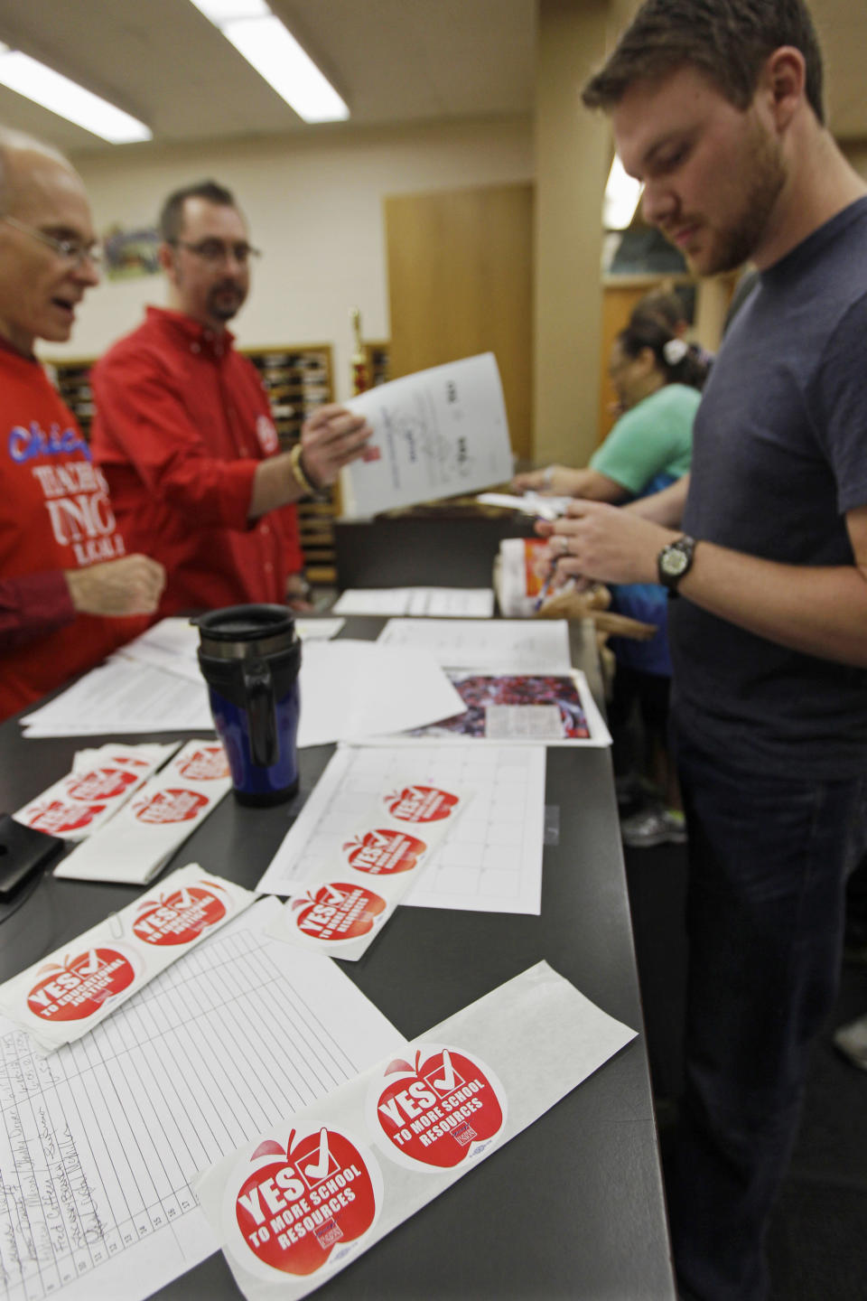 Members of the Chicago Teachers Union cast their ballots during a strike authorization vote at a Chicago high school Wednesday, June 6, 2012. Chicago Teachers Union President Karen Lewis says union members don't want to disrupt the start of the next school year with a strike, but she says they feel voting to authorize one is needed to negotiate a better contract. (AP Photo/M. Spencer Green)