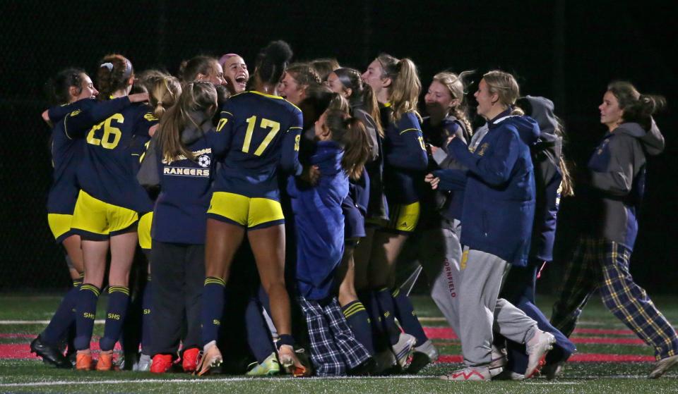 Spencerport players celebrate as the final buzzer sounds giving Spencerport the 3-0 victory over Schroeder in their Section V Class AA girls soccer final.