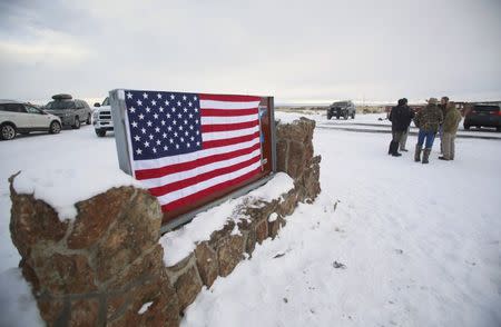 A U.S. flag covers a sign at the entrance of the Malheur National Wildlife Refuge near Burns, Oregon, U.S. January 3, 2016. REUTERS/Jim Urquhart/File Photo