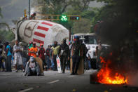 Demonstrators stand near a truck as they use it as a barricade while clashing with riot security forces during a rally called by healthcare workers and opposition activists against Venezuela's President Nicolas Maduro in Caracas, Venezuela May 22, 2017. REUTERS/Carlos Barria