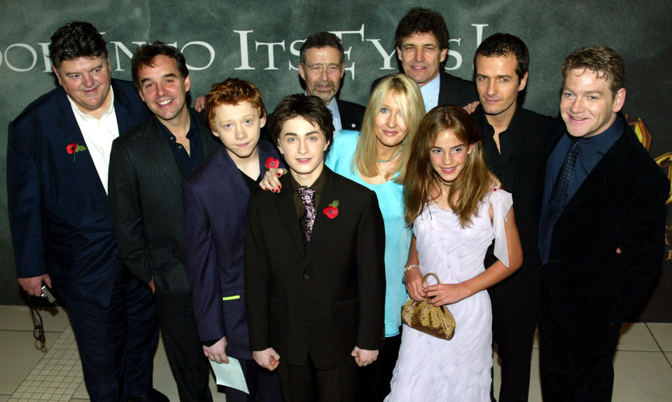 Cast including British actors Robbie Coltrane (L), Rupert Grint (3rd L), Daniel Radcliffe (4th L), Hermione Grainger (3rd R) and Kenneth Branagh (R), pose with director Chris Columbus (2nd L) and unidentified others at London's Odeon Leicester Square for the world premiere of "Harry Potter and the Chamber of Secrets" on November 3, 2002. The film, which is due to go on official release on November 15, 2002,  is the second screen adaptation from the series of Harry Potter books by British author [J K Rowling.]