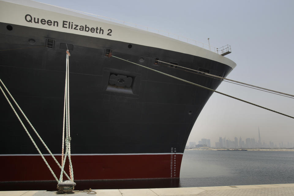 FILE - In this Monday, July 2, 2012 file photo, The Queen Elizabeth 2 is seen at dock as Istithmar World, the Dubai state investment company that owns the ship, outlined plans Monday to turn the retired cruise liner into a 300-room hotel, ending years of speculation about its fate, in Port Rashid, Dubai, United Arab Emirates. The Dubai owners of the storied passenger liner Queen Elizabeth 2 say the ship will be moved to Asia as a floating luxury hotel. (AP Photo/Kamran Jebreili, File)