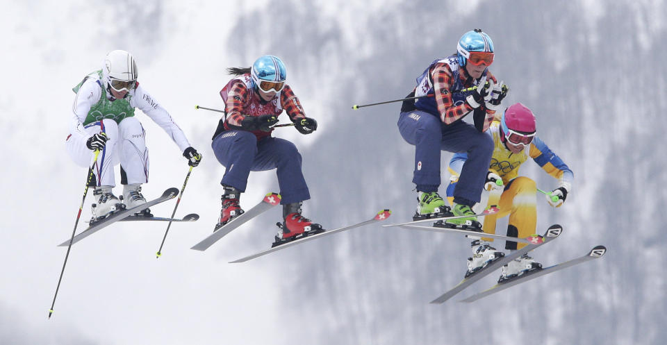 France's Ophelie David, Canada's Kelsey Serwa, Canada's Marielle Thompson and Sweden's Anna Holmlund (from left) compete in the ski cross final at the 2014 Winter Olympics, Feb. 21, 2014, in Krasnaya Polyana, Russia.