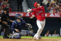 Los Angeles Angels designated hitter Shohei Ohtani, right, hits a pop fly for an out to Minnesota Twins third baseman Gio Urshela as Twins catcher Gary Sanchez, center, and home plate umpire Dan Bellino, left, look on during the sixth inning of a baseball game in Anaheim, Calif., Saturday, Aug. 13, 2022. (AP Photo/Alex Gallardo)