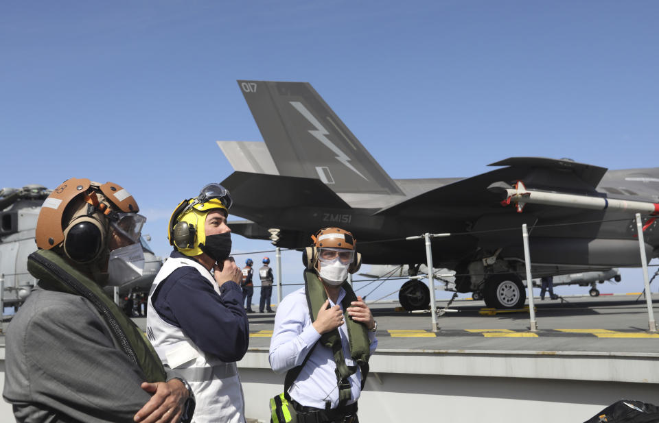 NATO Secretary General Jens Stoltenberg, right, observes the NATO Steadfast Defender 2021 exercise on board the aircraft carrier HMS Queen Elizabeth off the coast of Portugal, Thursday, May 27, 2021. NATO has helped provide security in Afghanistan for almost two decades but the government and armed forces in the conflict-torn country are strong enough to stand on their own feet without international troops to back them, the head of the military organization said Thursday. (AP Photo/Ana Brigida)