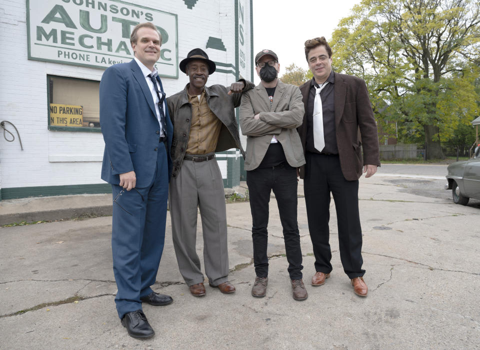 This image released by Warner Bros. Entertainment shows director Steven Soderbergh, second from right, with actors, from left, David Harbour, Don Cheadle and Benicio Del Toro, right, on the set of "No Sudden Move." (Claudette Barius/Warner Bros. Entertainment via AP)